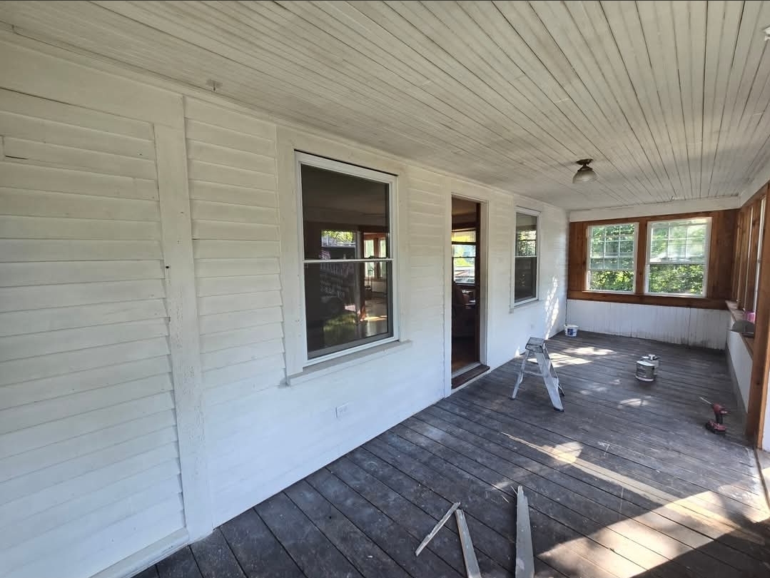 Enclosed porch before painting and floor replacement