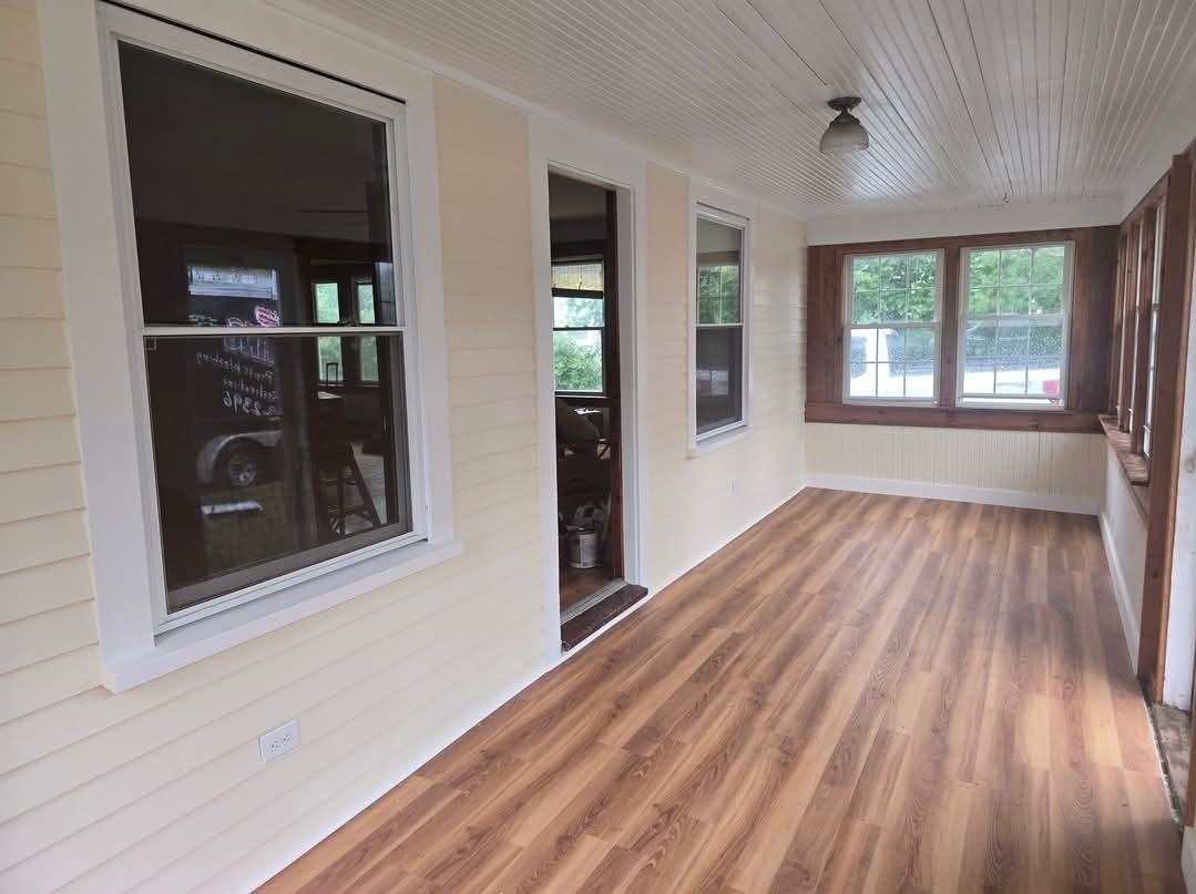Enclosed porch after painting with new wood-look flooring