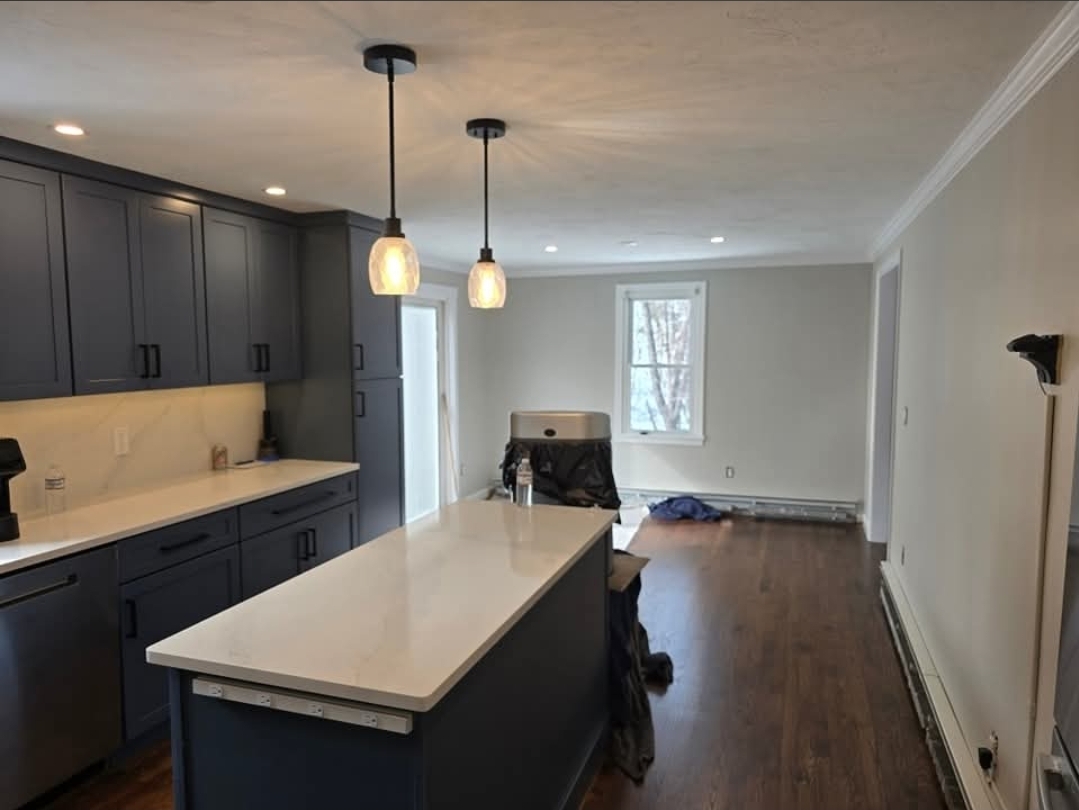 Kitchen with navy cabinetry and freshly painted walls and ceiling