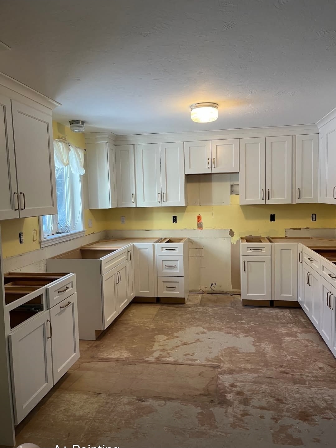 Kitchen mid-project with cabinets primed and painted